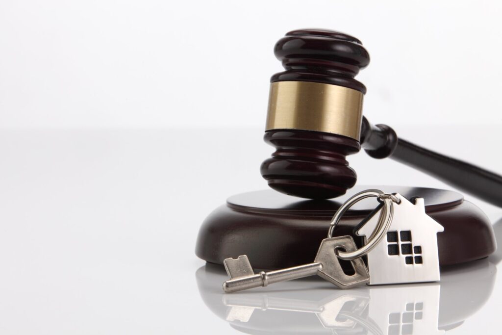Wooden Gavel and a key with a house on key ring
